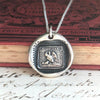 Mothers necklace wax seal with chain in front of a book