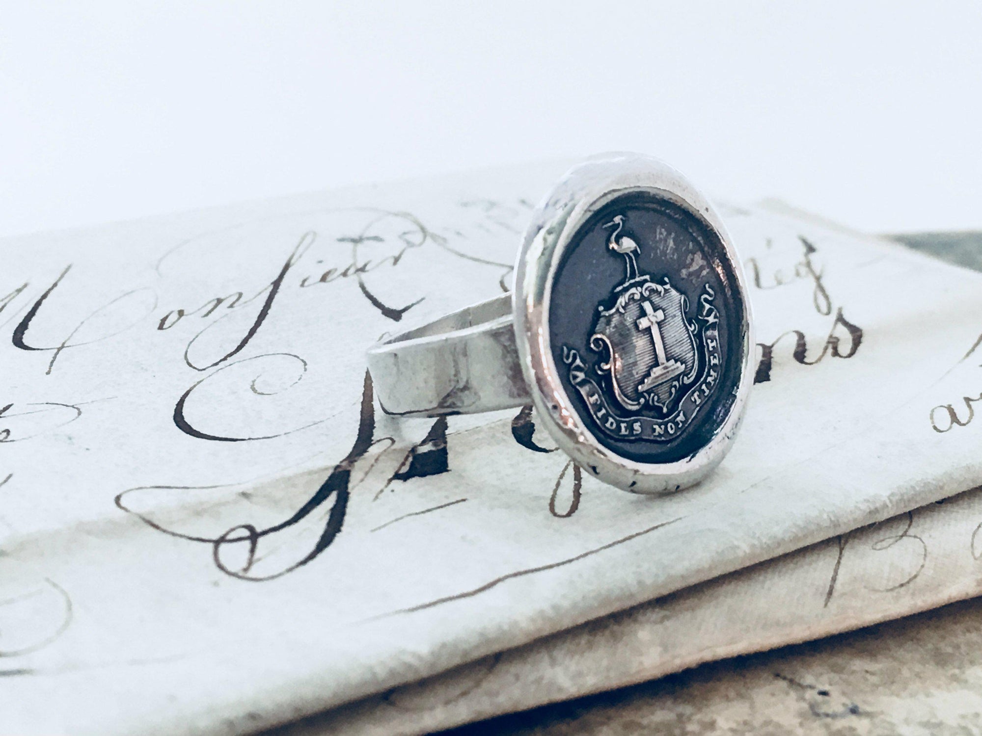 Faith wax seal ring in front of a pen