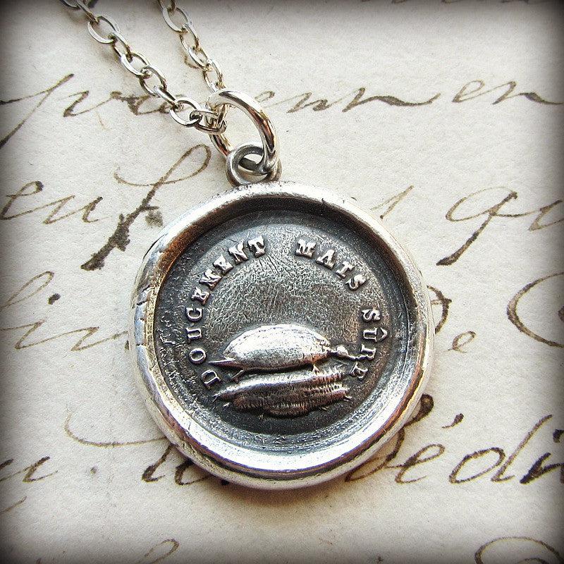 Turtle wax seal necklace on a paper