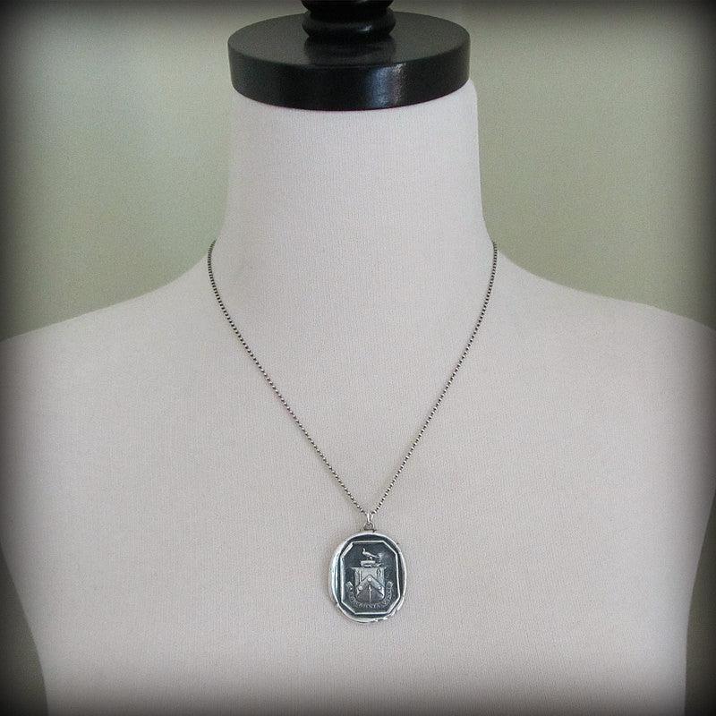 Labor conquers wax seal necklace on a mannequin