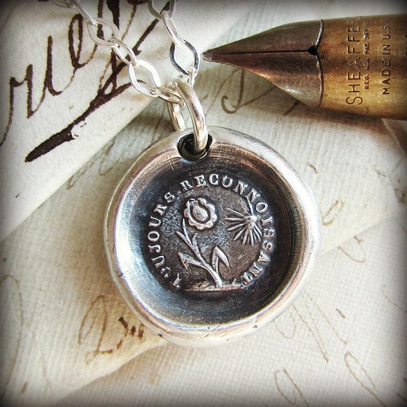 Flower and sun wax seal necklace close up shot