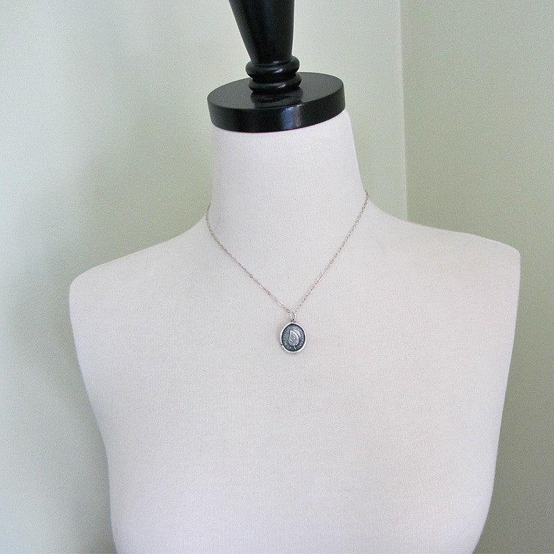 Leaf wax seal necklace on a mannequin