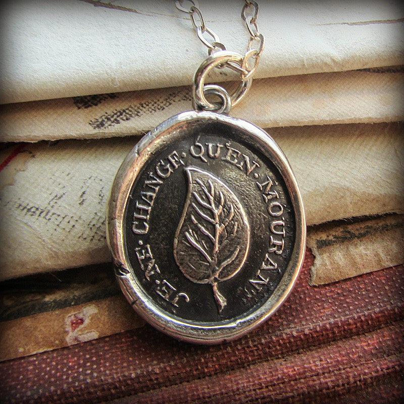 Leaf wax seal necklace on a piece of paper