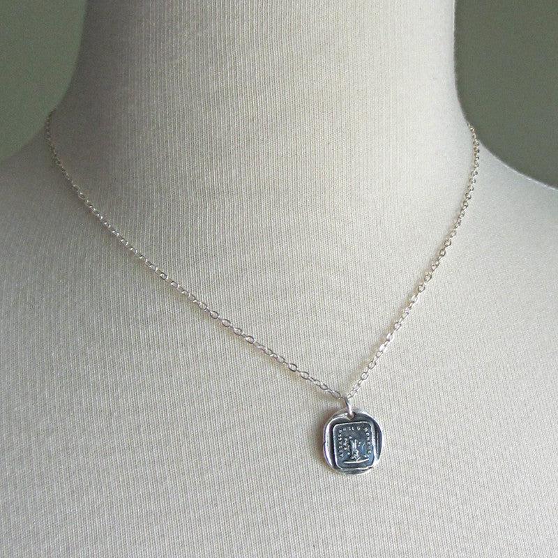 Attached until death wax seal pendant on a mannequin