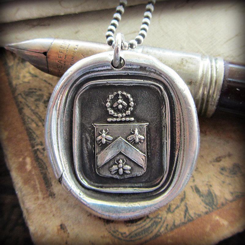 Bee crest wax seal hanging over a pen