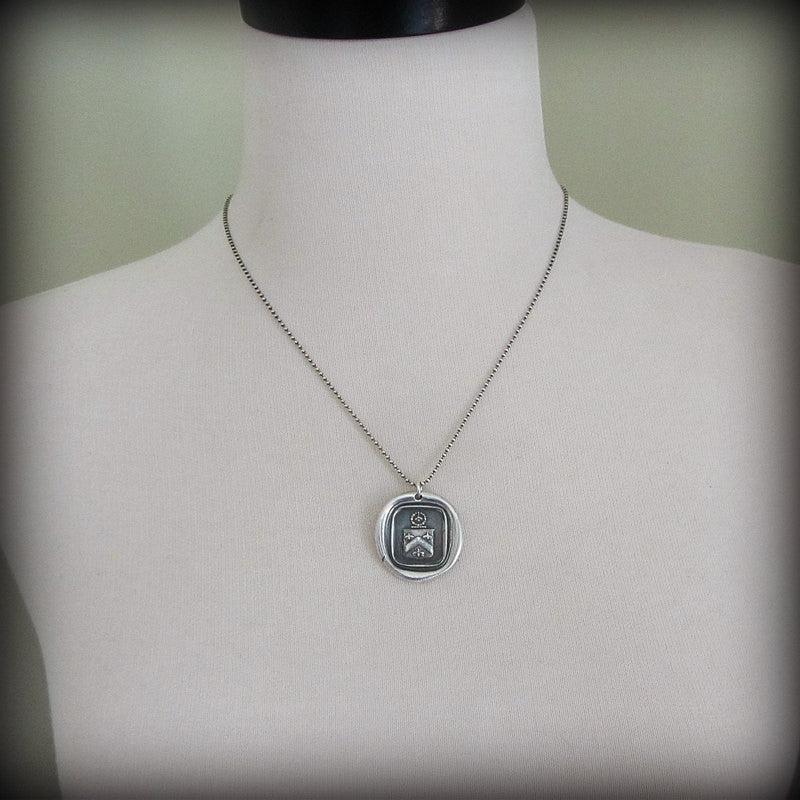 Bee Wax Seal Crest Necklace on a mannequin