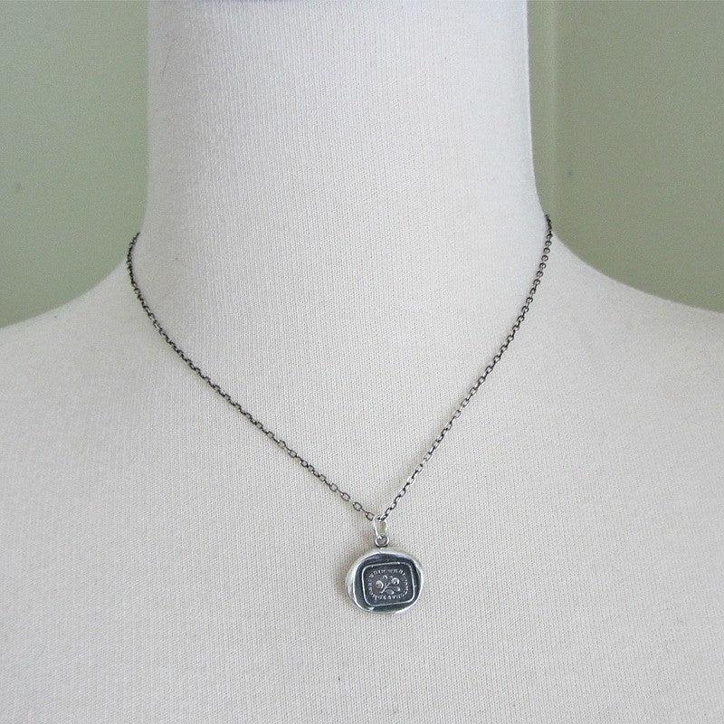 Bloom today wax seal necklace on a mannequin