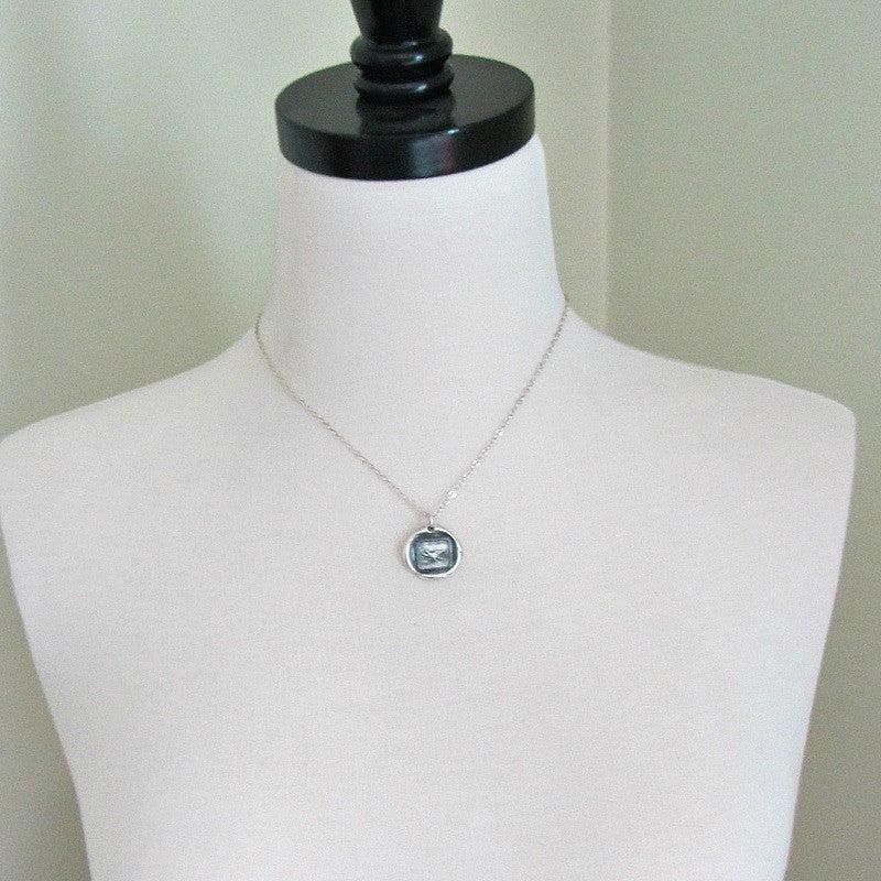 Eagle soaring wax seal necklace on a mannequin