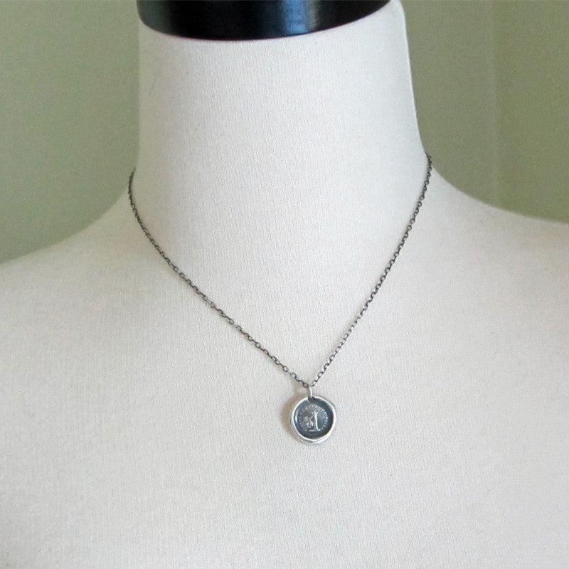 Broken tree wax seal necklace on a mannequin