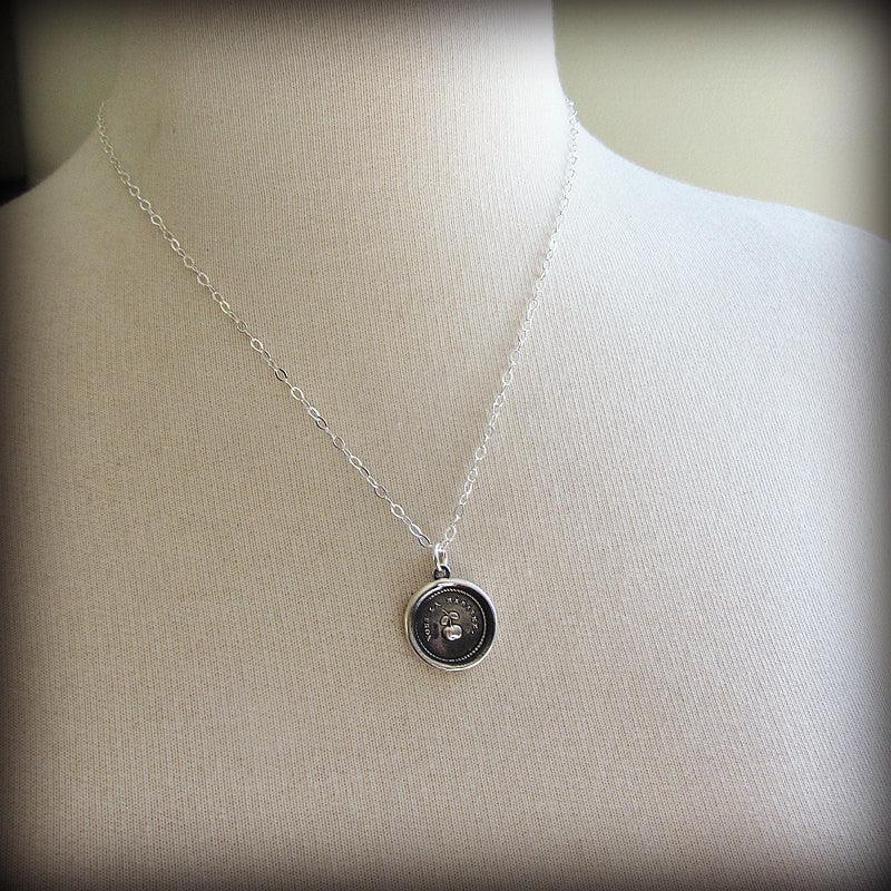 Cherry wax seal necklace on a mannequin