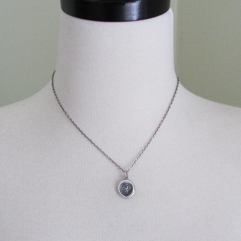 Lion in a heart wax seal necklace on a mannequin