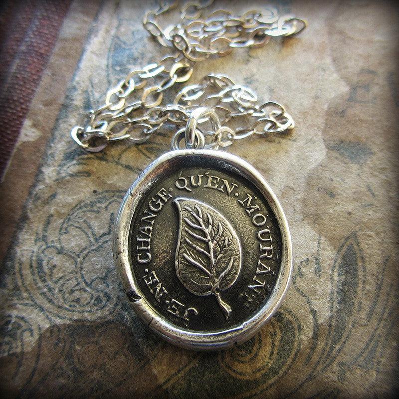 Leaf wax seal necklace on a piece of paper