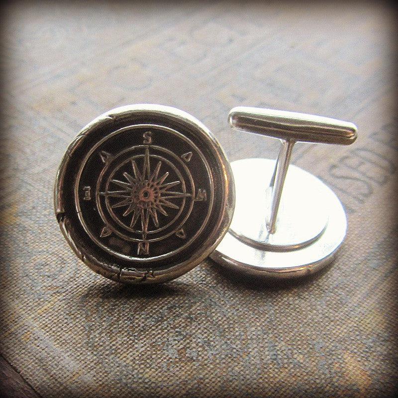 Compass cuff links close up