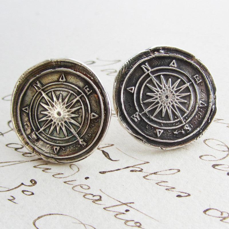 Compass earrings close up