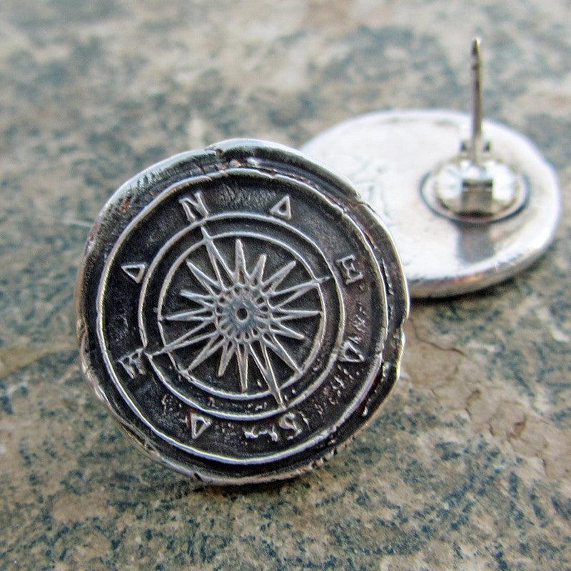 Compass earrings on marble 
