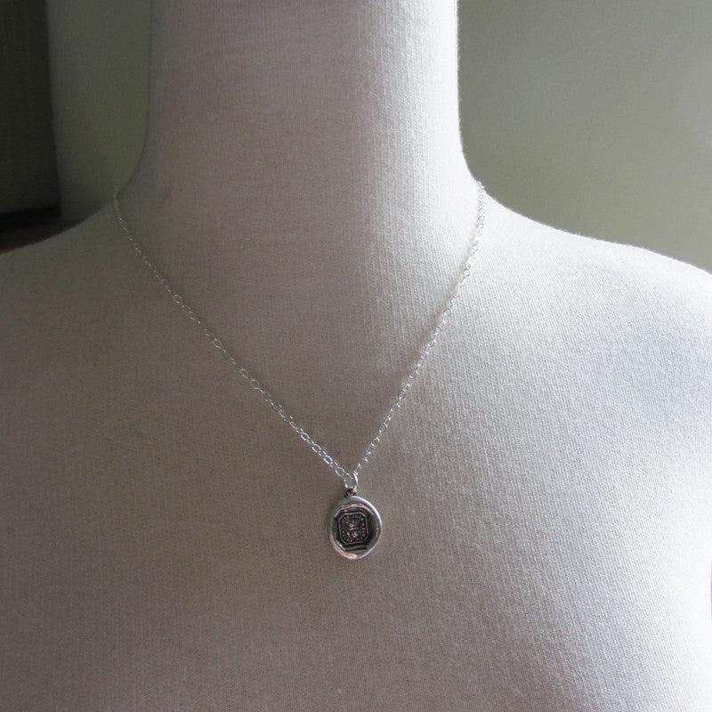 Crown Rose wax seal charm on a mannequin