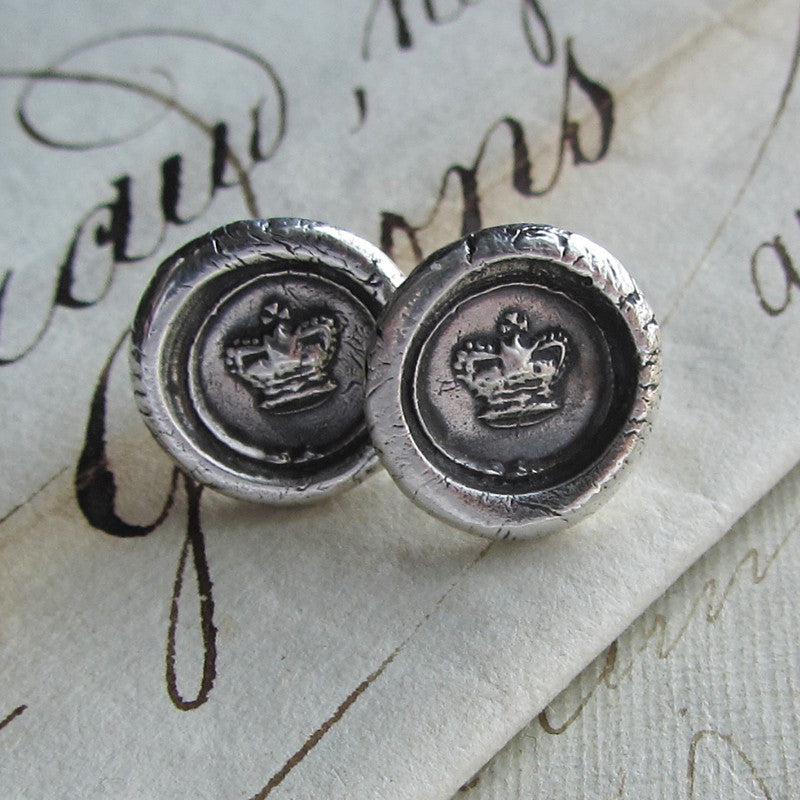Tiny Crown Wax Seal Earrings on paper
