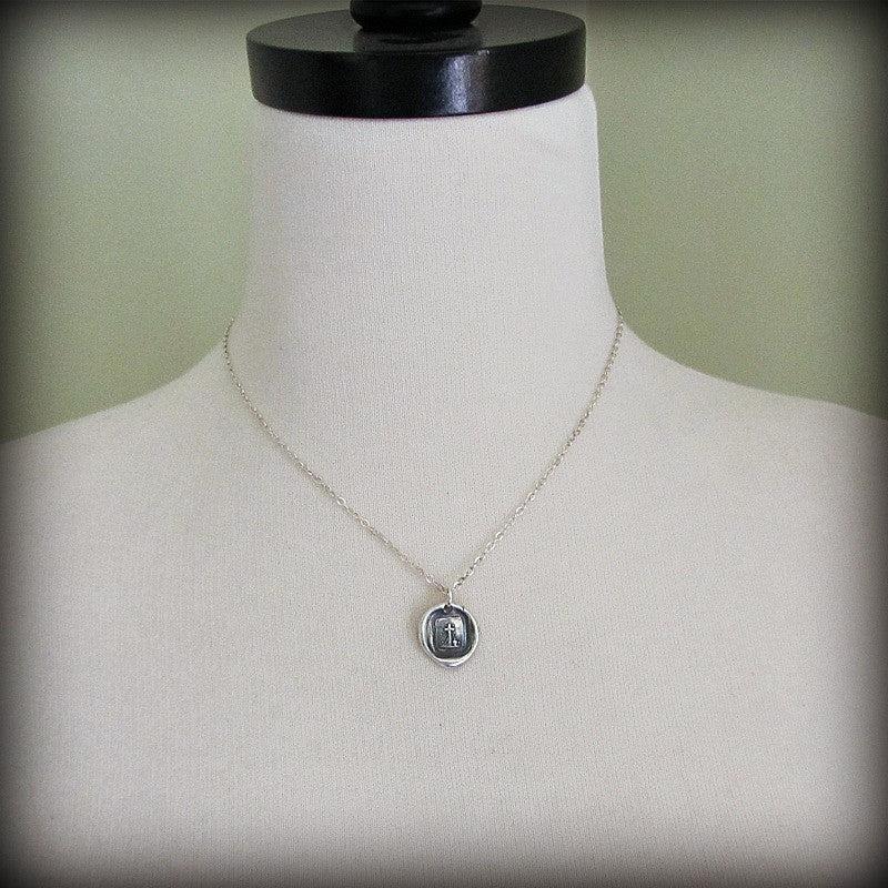 Little cross wax seal necklace on a mannequin