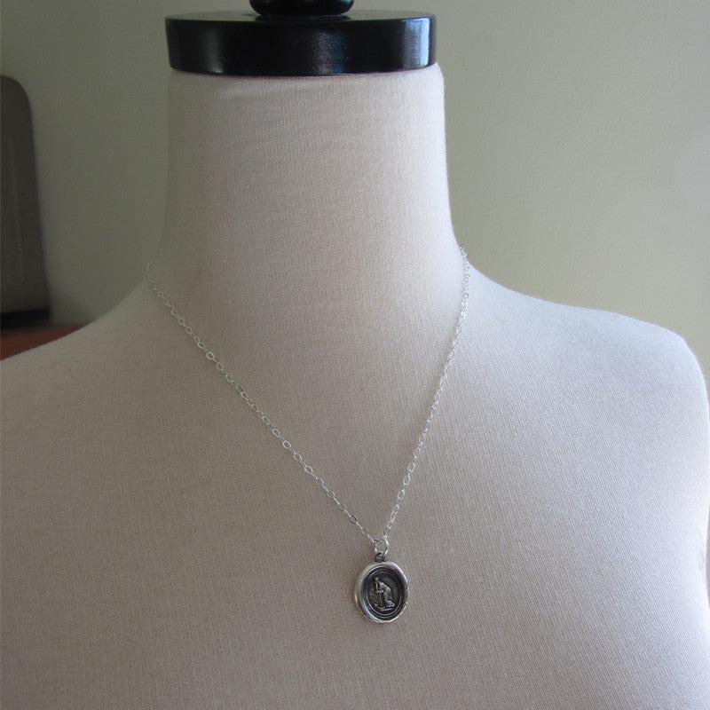 Faith leaning on hope wax seal on a mannequin