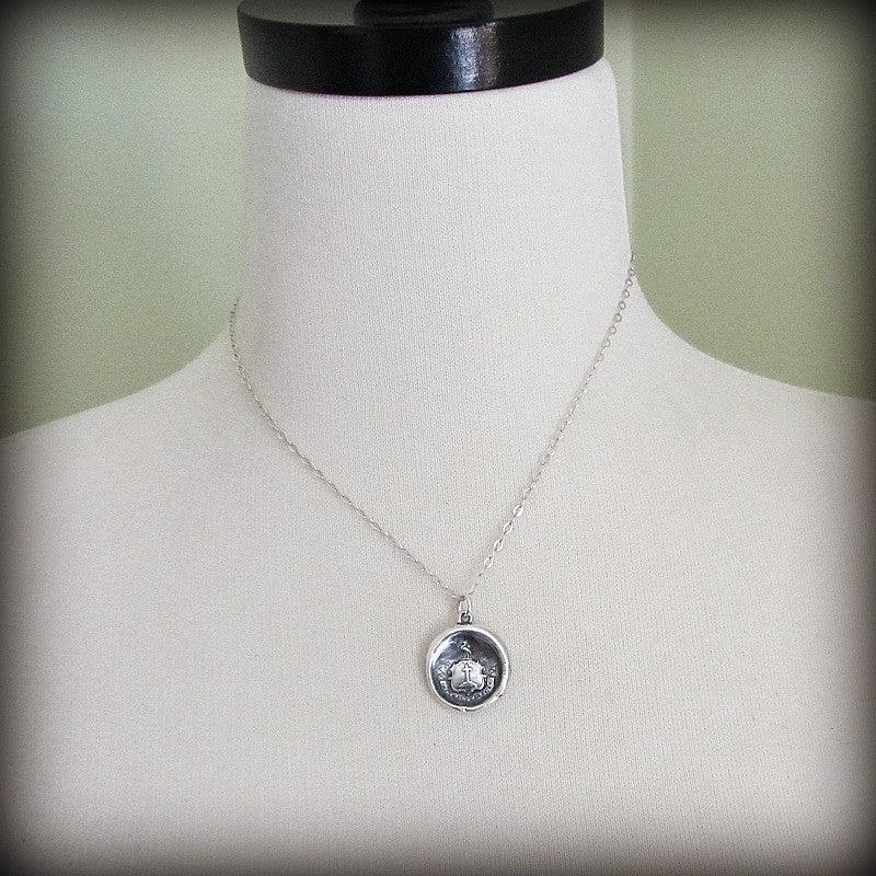 Faith wax seal necklace on a mannequin