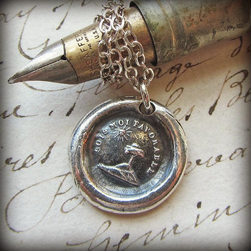 Tree and sun wax seal necklace wrapped around a chain