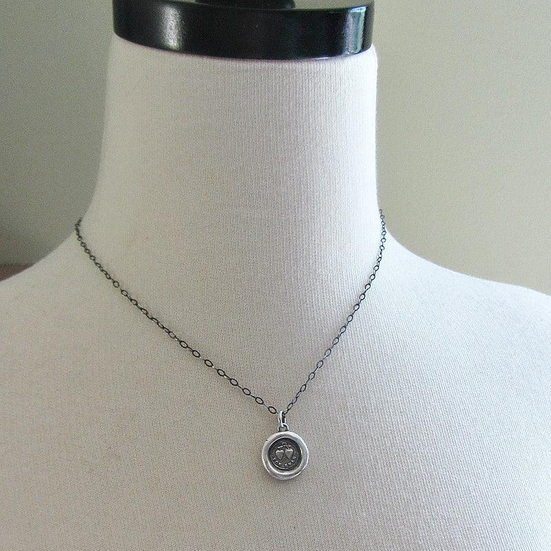 two heats for ever wax seal necklace on a mannequin