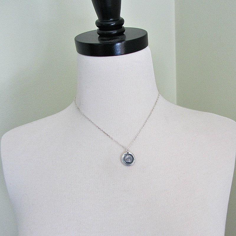 Grasshopper wax seal necklace on a mannequin