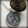 Family tree wax seal necklace next to stamp