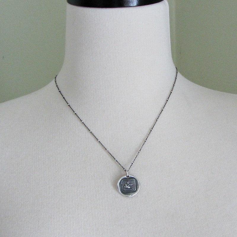 Peace dove necklace on a mannequin