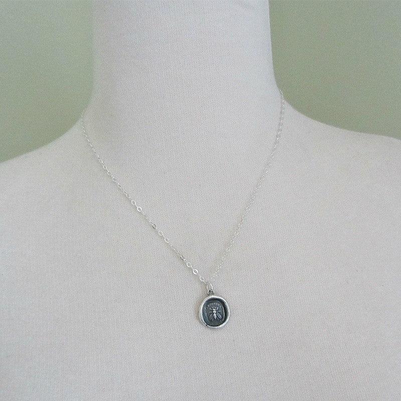 Large bee wax seal necklace on a mannequin