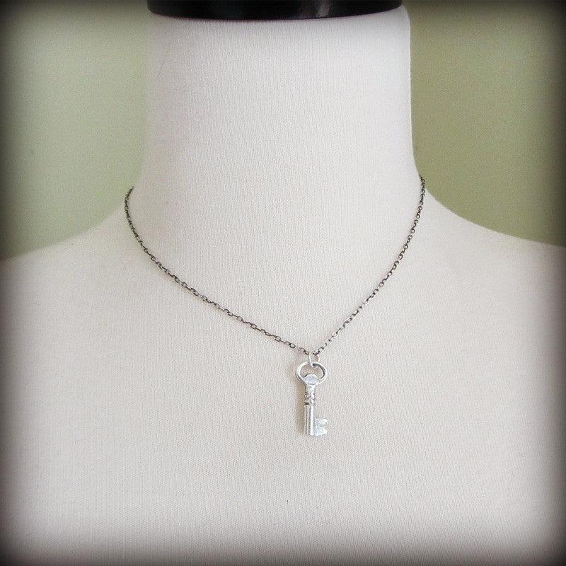 Vintage Key Charm on a mannequin