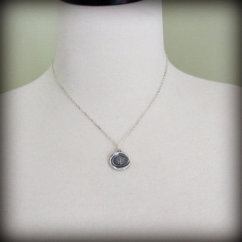 Key arrow wax seal pendant on a mannequin