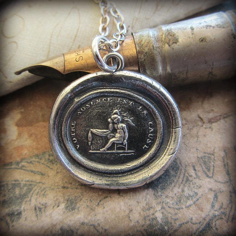 Your Absence is the Cause wax seal necklace on a pen