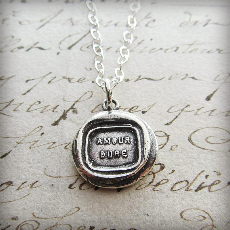 Love lasts french wax seal pendant with a silver chain