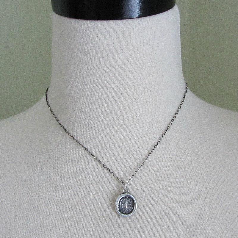 Large compass wax seal necklace on a mannequin