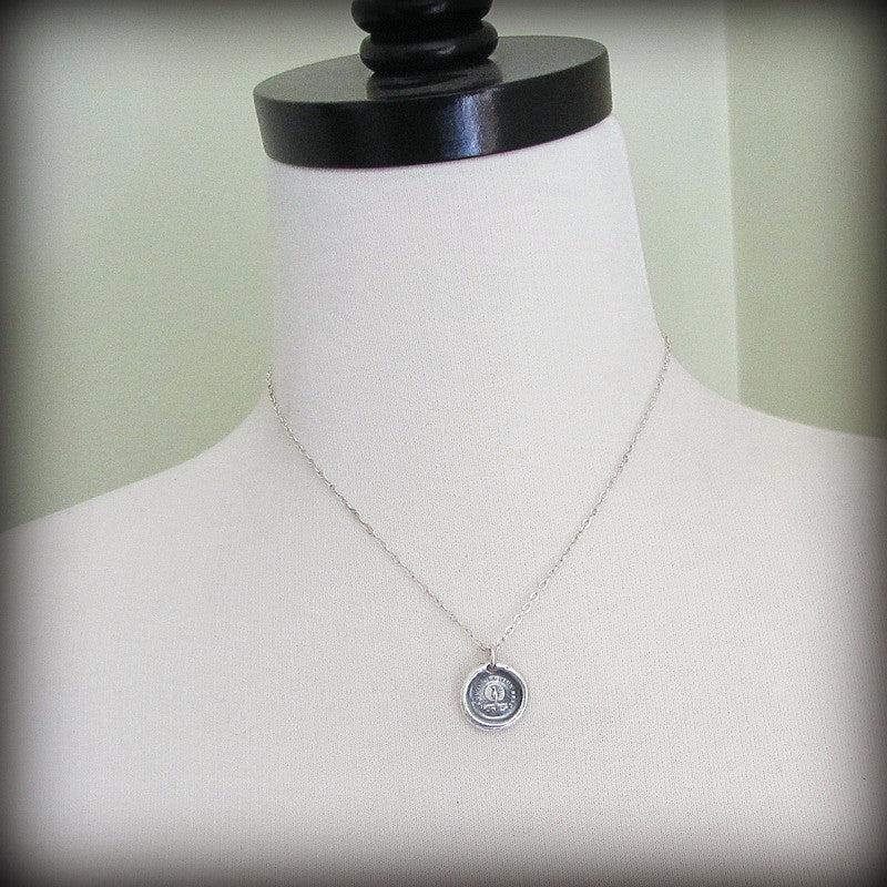 Peacock Wax Seal Necklace on a mannequin