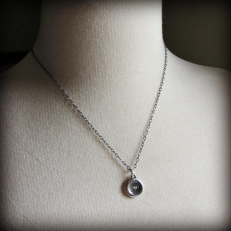 Tiny Heart Wax Seal Necklace on a mannequin