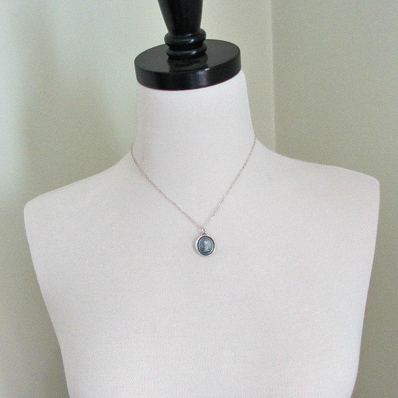 Prosperity Wax Seal Necklace on a mannequin