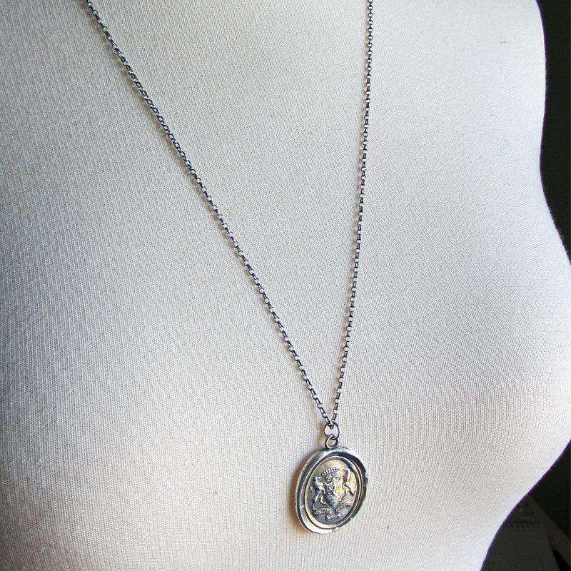 Crest with lions wax seal necklace on a mannequin