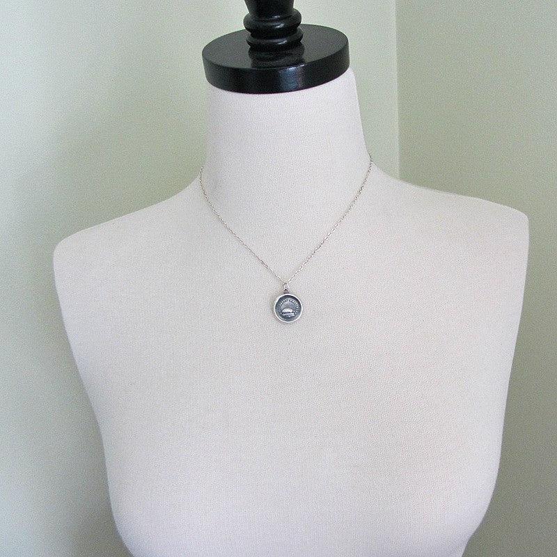 Turtle wax seal necklace on a mannequin