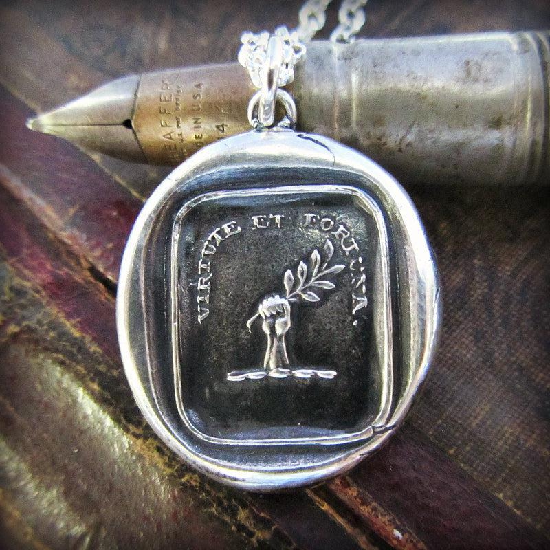 virtue and fortune wax seal over a pen