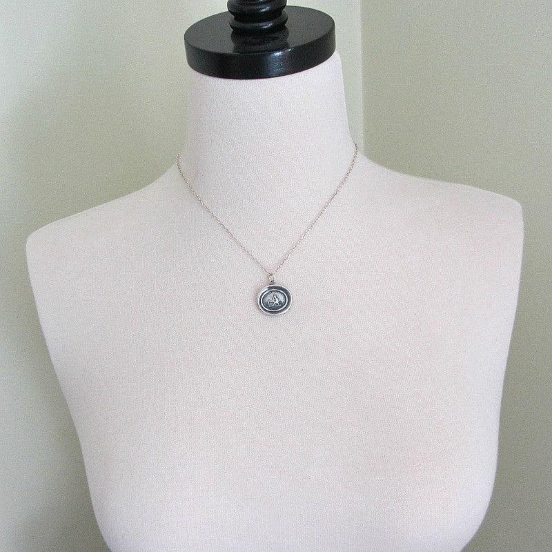 Your Absence is the Cause wax seal necklace on a mannequin