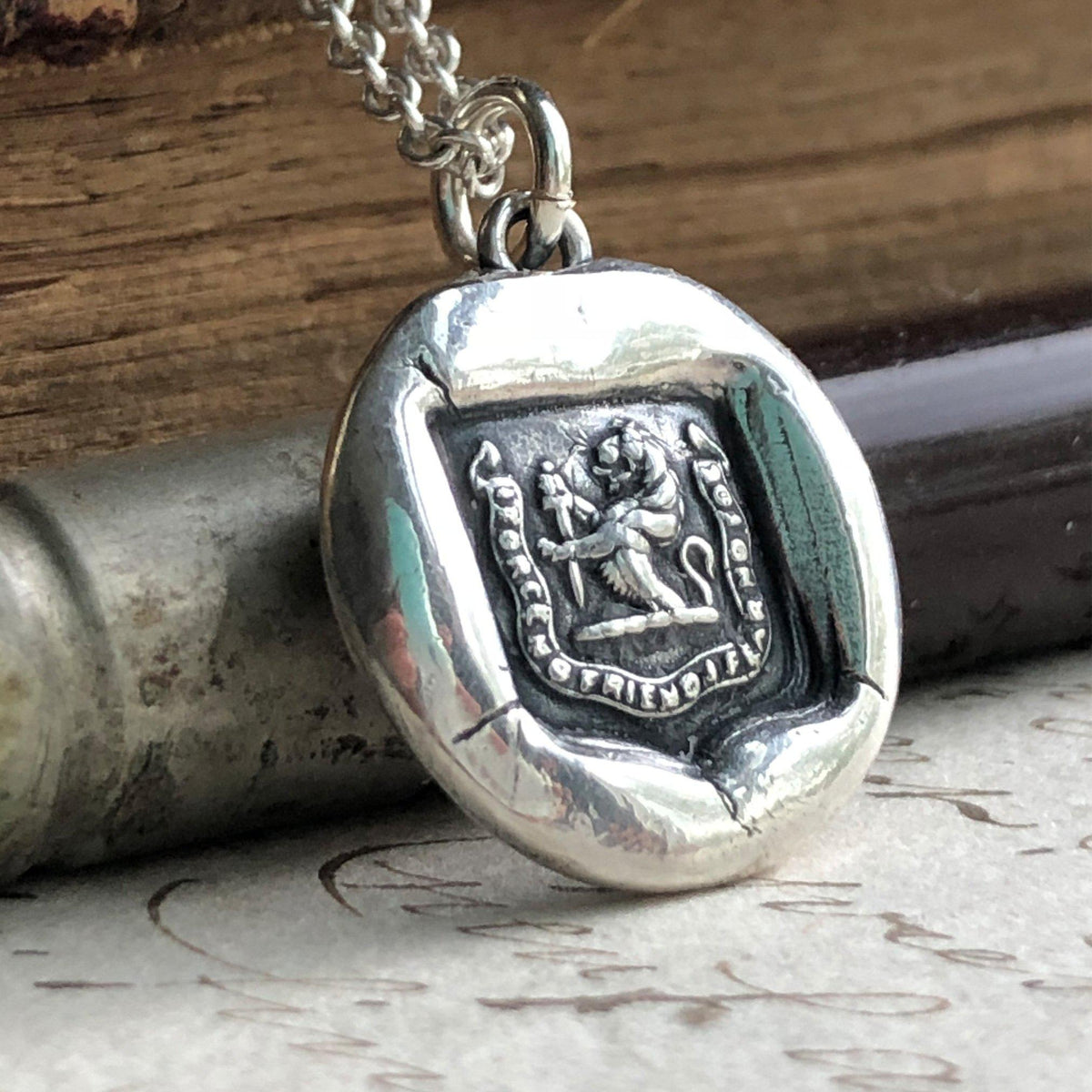 Lion and sward wax seal with a silver chain