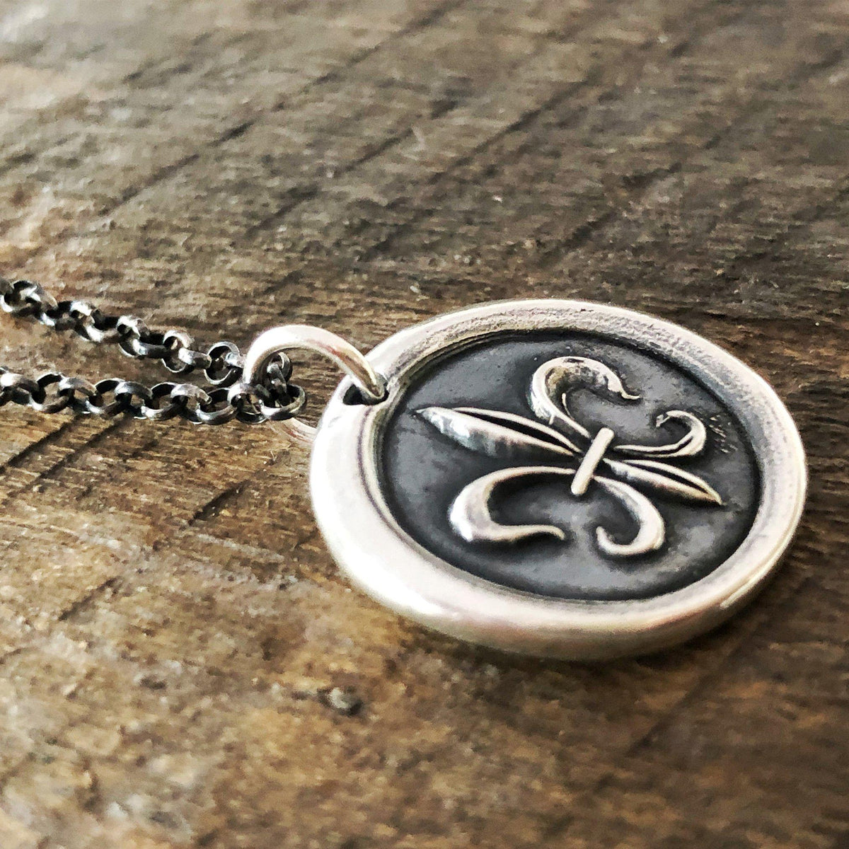 Fleur wax seal with a dark chain