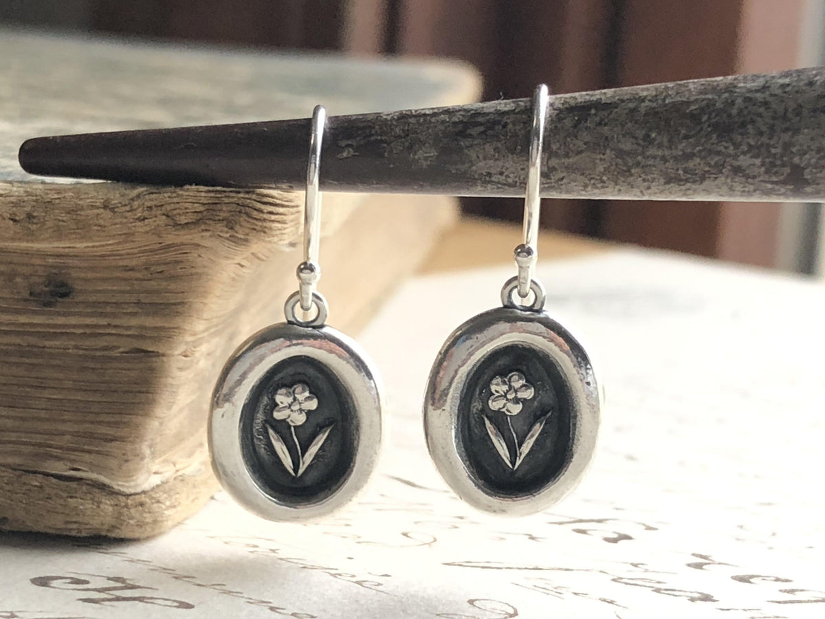 Tiny flower wax seal earrings hanging