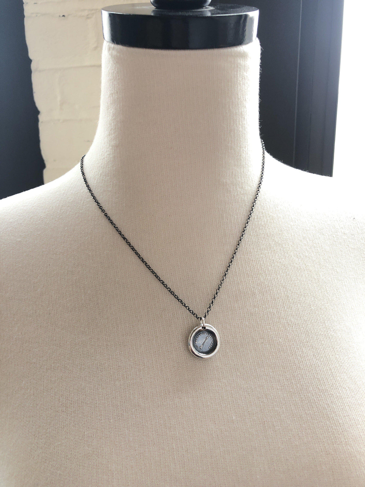 Arrow pendant wax seal necklace on a mannequin 