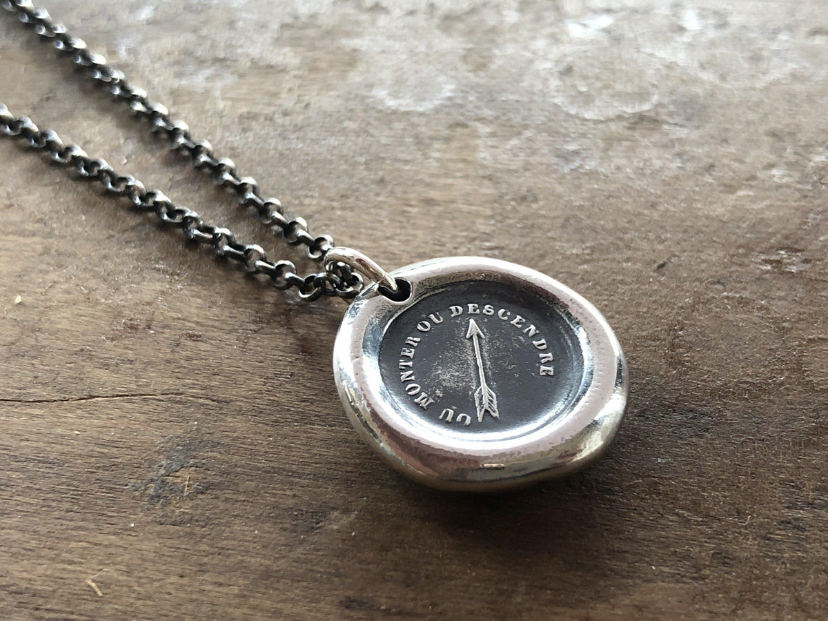 Arrow pendant displayed on wood