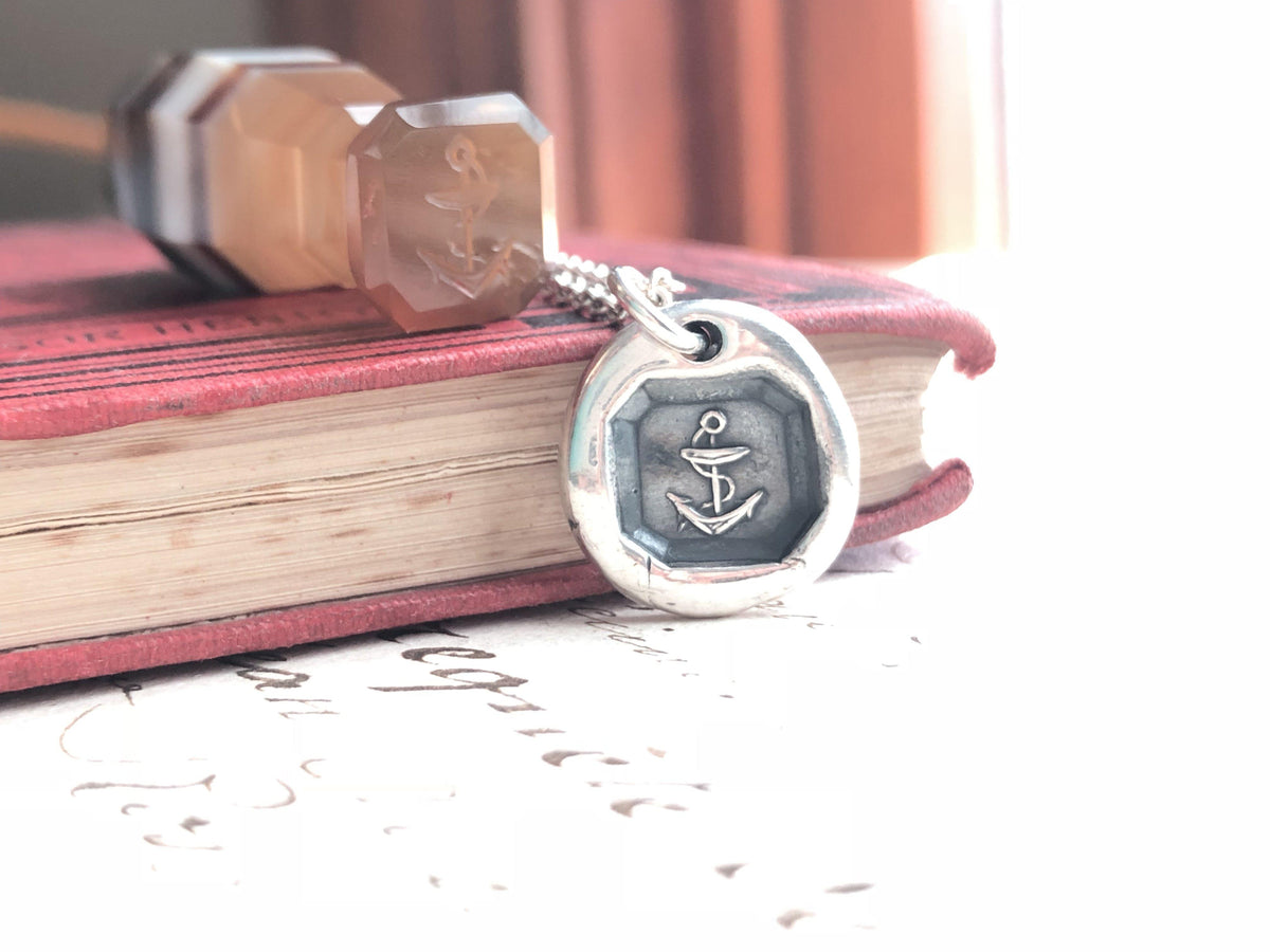 Anchor Necklace with pendant on a book