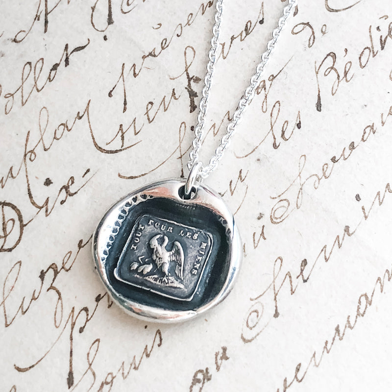 Mothers necklace wax seal with chain in front of a book
