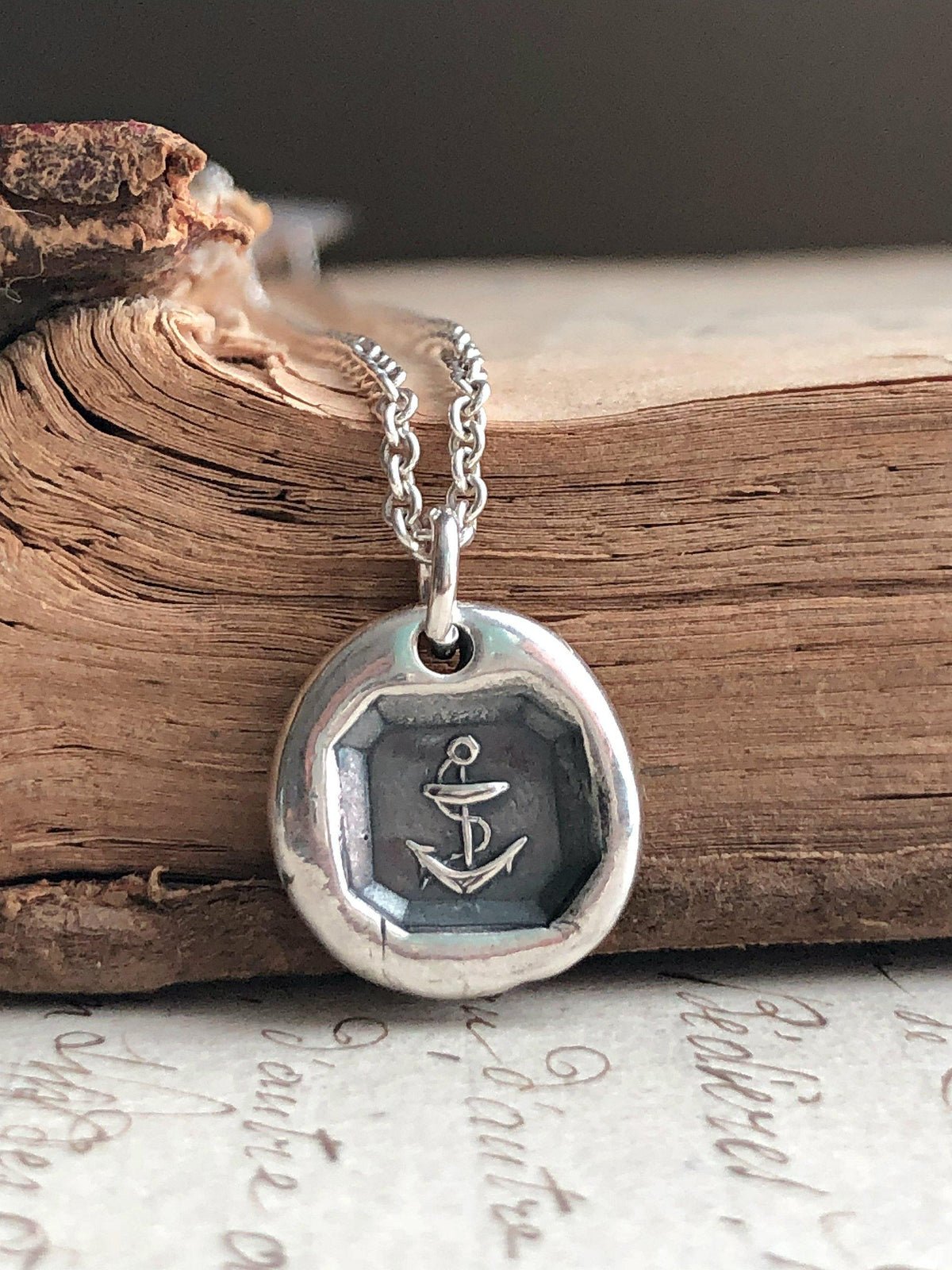 Anchor Necklace with pendant on an old book